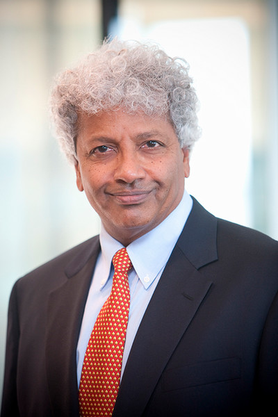 Portrait photo of Mahadev Satyanarayanan in a dark blue suit and bright red pattered tie.