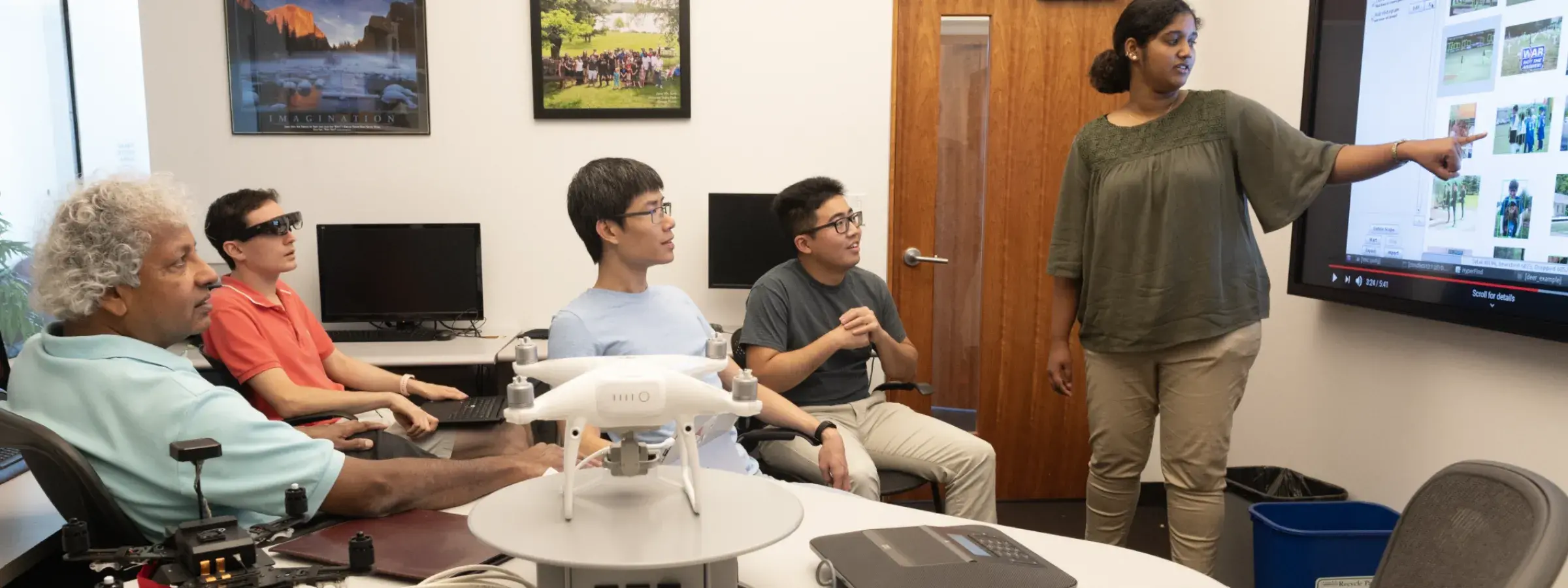 Satya and 4 students reviewing research